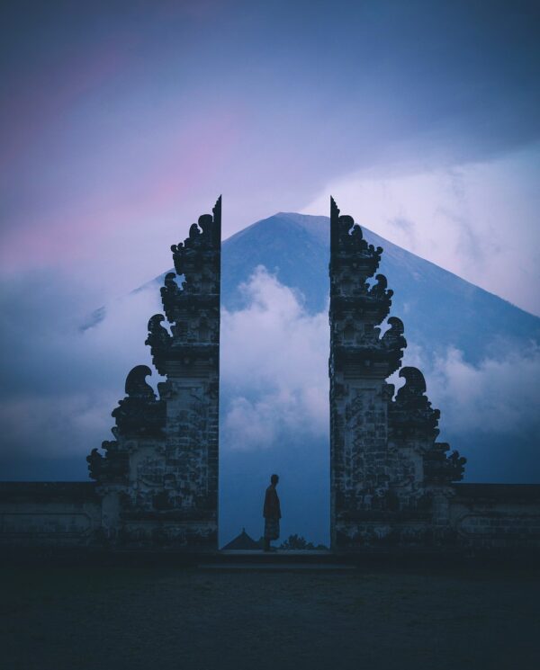 Person undergoing past life regression in serene Bali evening