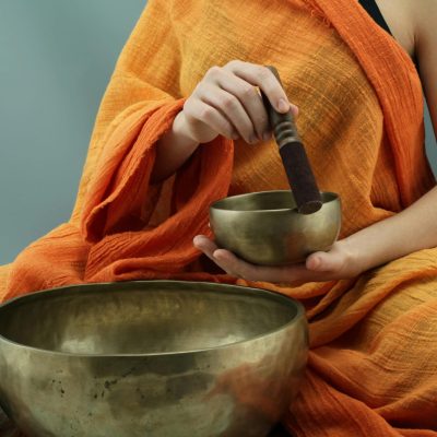 Person performing sound healing with a Tibetan singing bowl