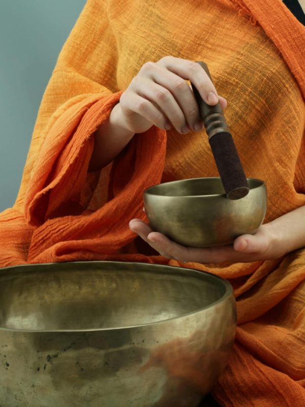 Person performing sound healing with a Tibetan singing bowl